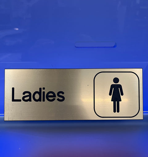 Ladies Washroom Sign on Gold (8" x 3")